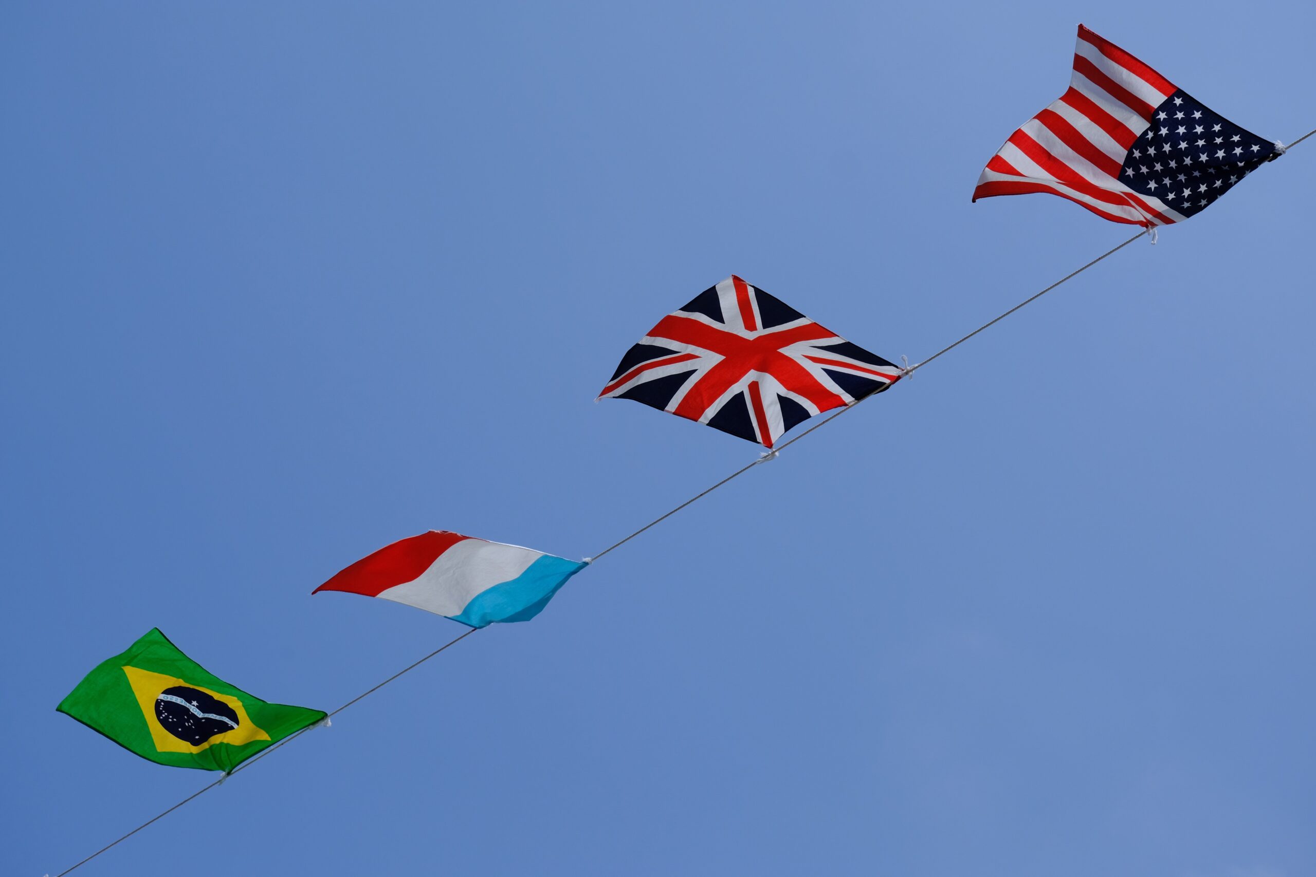 Four flags against a blue sky